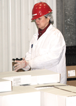 A Truebridge employee checking a pallet full of boxed product.